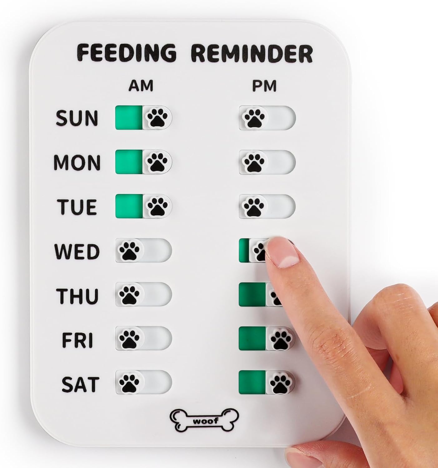 White pet feeding reminder board with AM/PM paw print sliders, a hand setting a green indicator.