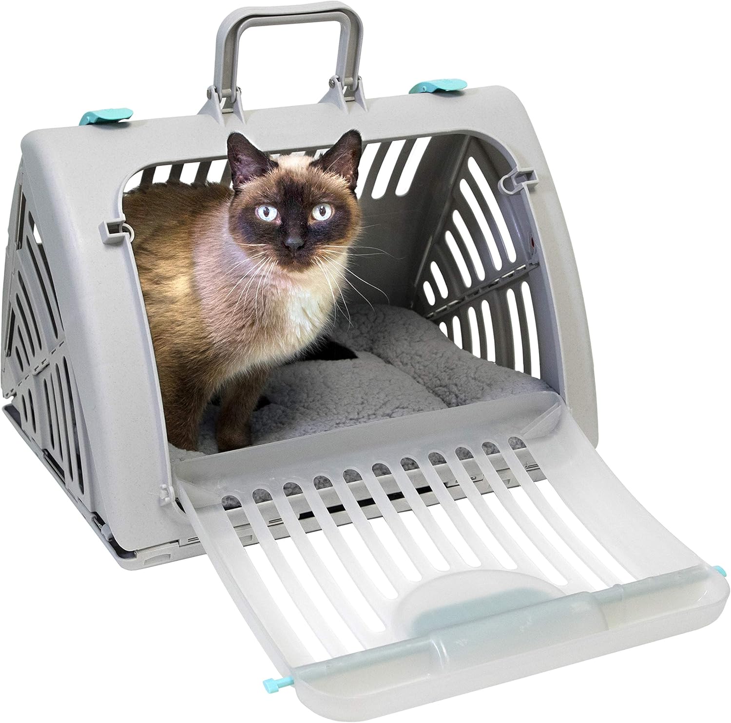 Light gray pet carrier with door ramp, a blue-eyed Siamese cat peeking out on a beige mat.
