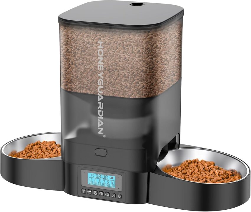Sleek black automatic pet food dispenser with transparent top, kibble, and two steel bowls.