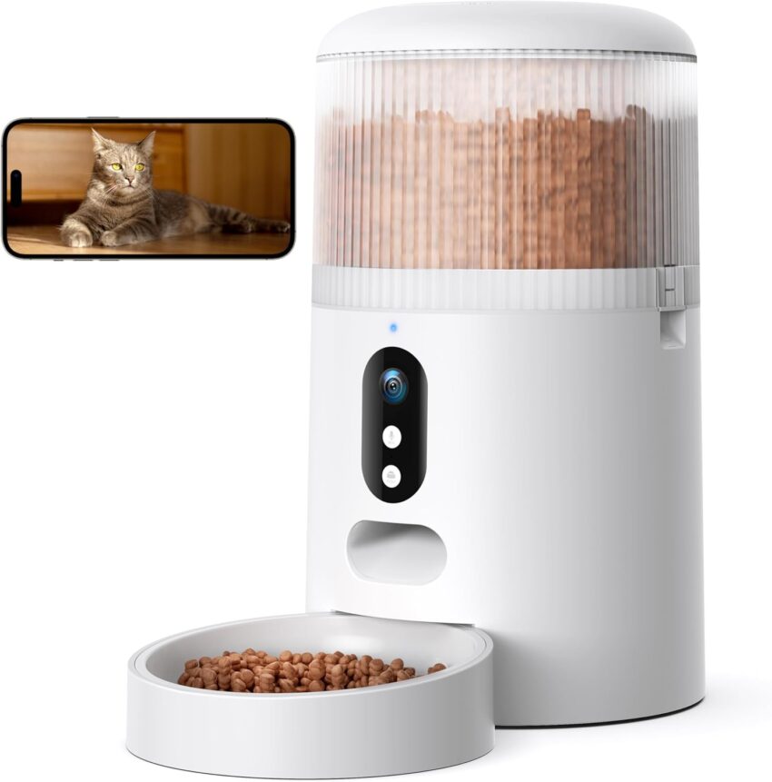 Sleek white automatic pet feeder with camera, kibble, and smartphone, flanked by two other smart dispensers.