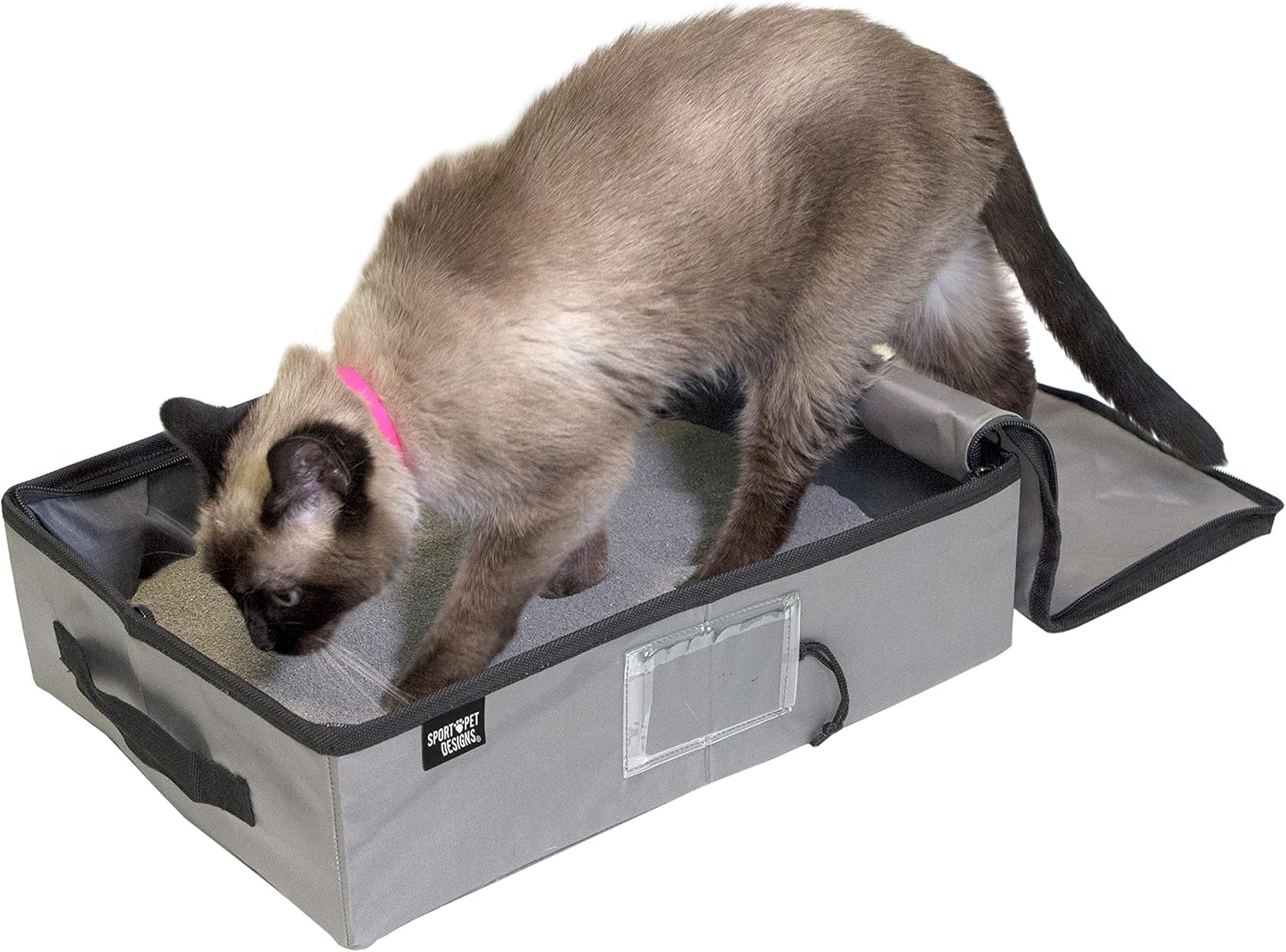 Siamese cat digs in light sand inside an open gray foldable litter box with handles, beside a collapsed unit.