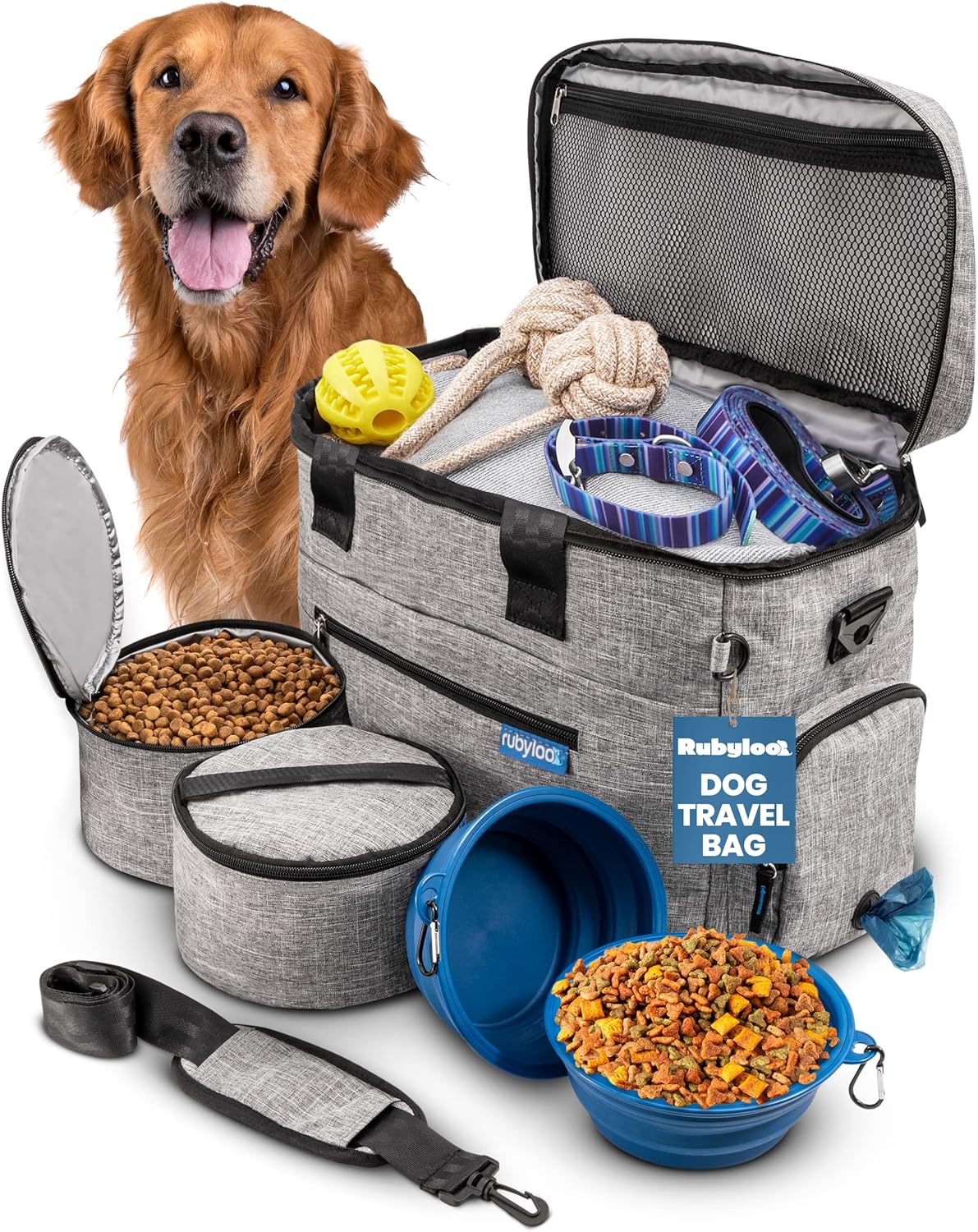 Open gray dog travel bag surrounded by colorful toys, blue collars, collapsible bowls, and pet travel essentials.